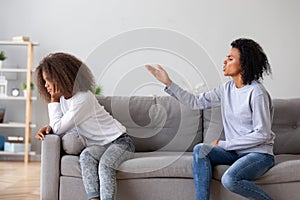 Angry aggressive mother scolding teen daughter at home