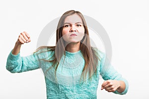 Angry aggressive woman with ferocious expression on white background