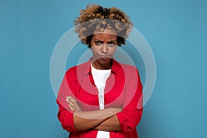 Angry annoyed african woman keeping arms crossed and staring at camera with sceptical and distrustful look