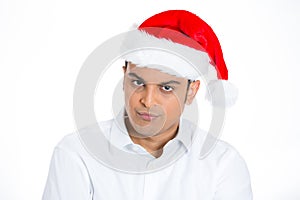 Angry, annoyed man in red santa hat