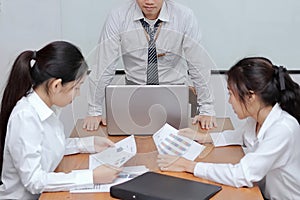 Angry asian boss standing and feeling displeased during meeting in office