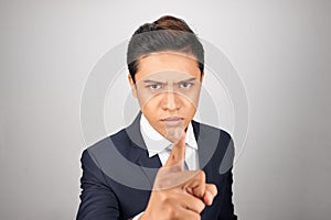 Angry Asian businessman on white background