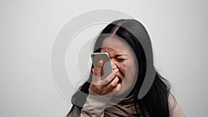 Angry Asian woman screaming on her phone