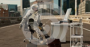 Angry astronaut, city and breaking computer with road for stress, anxiety or vandalism in an urban town. Frustrated