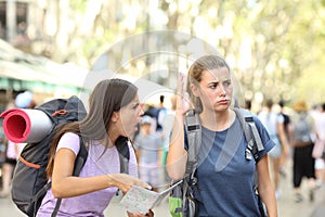 Angry backpackers arguing during vacation travel photo