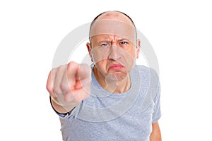 Angry baldheaded man pointing in to the camera and smiling photo