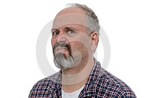 Angry balding man with beard sneers at the camera