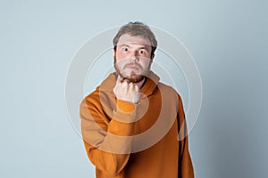 Angry bearded young man raising fist frustrated and furious. Rage and aggressive concept