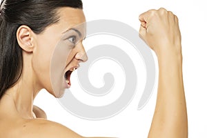 Angry beautiful woman threatening with the fist