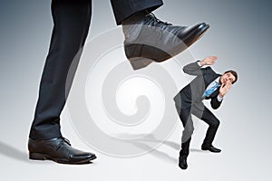 Angry big businessman is abusing small employee