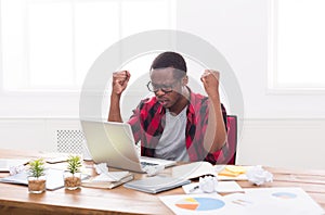 Angry black businessman in office, work with laptop