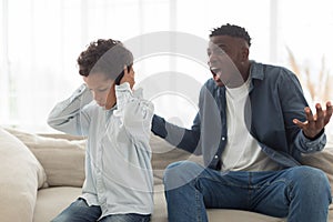 Angry Black Father Shouting At Scared Little Son At Home