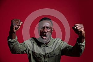 Angry Black Man with Fists Raised on Isolated Background