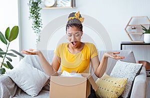 Angry black woman unpacking wrong box, delivery mistake