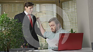 Angry boss checks report a young guy in a suit, employee. Work in the office concept. 60 fps