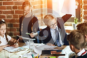 Angry boss with clenched teeth looks furiously at his colleague