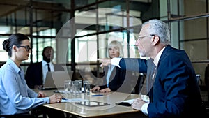 Angry boss dismissing employee, unhappy with work results pointing at door