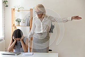 Angry boss dismissing subordinate pointing with hand to door