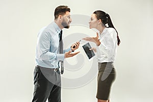 Angry boss. Man and his secretary standing at office or studio