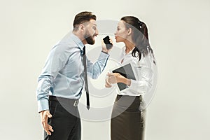 Angry boss. Man and his secretary standing at office or studio