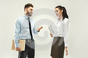Angry boss. Man and his secretary standing at office or studio