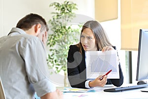 Angry boss scolding to an employee photo