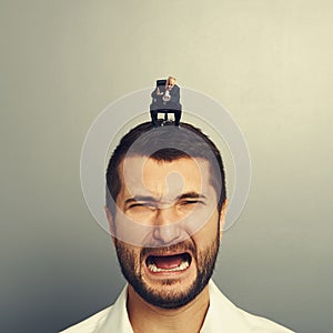 Angry boss screaming at crying man