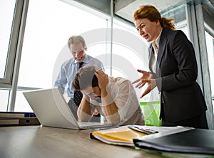 Angry boss screaming at workers