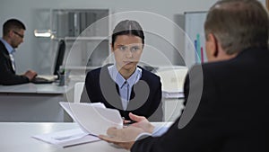 Angry boss shouting on sorrowful female manager made mistake in documents