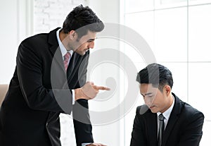 Angry boss standing opposite scolding at employee for missing deadline, executive manager scolding ineffective salesman showing