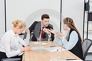 angry boss talking with his female colleagues