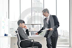 Angry boss yelling at employee, business concept, Asian businessman