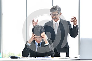 Angry boss yelling at employee, business concept, Asian businessman