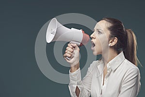 Angry bossy woman shouting through a megaphone