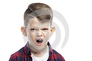 Angry boy of 7 years without a front tooth. Close-up. Isolated on white background