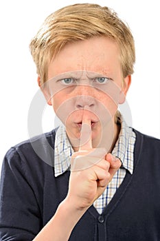 Angry boy with finger on lips
