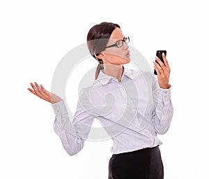 Angry brunette businesswoman with cell phone