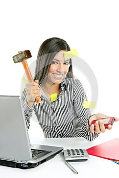 Angry brunette businesswoman with hammer
