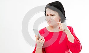 Angry brunette woman in red dress holding cell annoyed by not working smartphone, furious teen girl having problem with broken