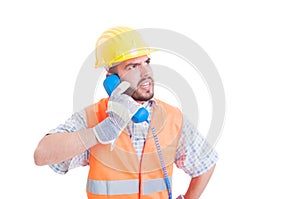 Angry builder having a conversation on the phone