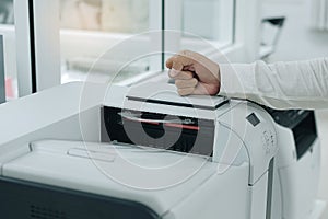 angry business man beats his fist on printer scanner