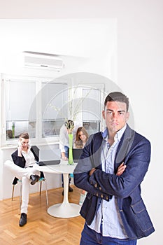 Angry business man in front of colleagues working as team