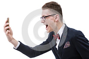 Angry business man screaming on cell mobile phone, portrait of y