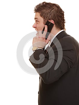 Angry business man talking on phone.