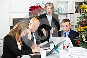 Angry business woman berating his managers pointing out shortcomings