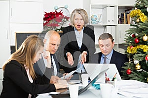 Angry business woman berating his managers pointing out shortcomings