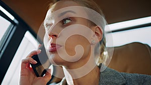 Angry business woman shouting by mobile phone at backseat. Girl arguing on phone