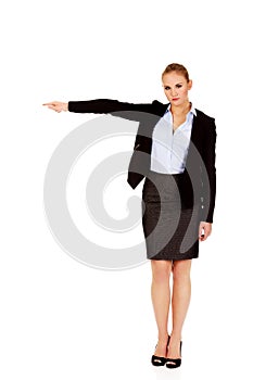Angry business woman shows get out gesture