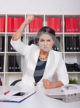 Angry business woman threaten with her fist. Dismissal concept