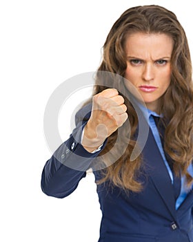 Angry business woman threatening with fist